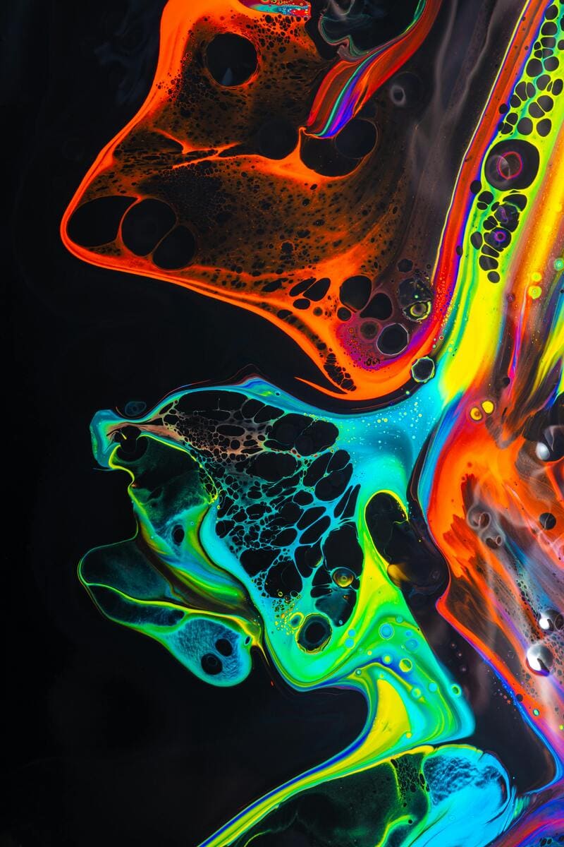 kara et compagnie photo melange colore de peintures au neon tourbillonnant sur une surface noire